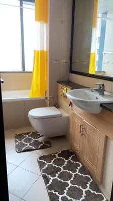 a bathroom with a sink and a toilet and a mirror at Click Stay - JLT - 2 Bedroom & Balcony Lakes view Entire Apartment -AZ in Dubai
