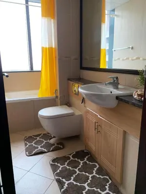 a bathroom with a toilet and a sink and a mirror at Click Stay - JLT - 2 Bedroom & Balcony Lakes view Entire Apartment -AZ in Dubai