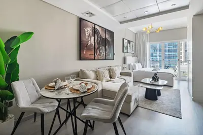 a living room with a couch and a table at Chic JLT Studio Lake View Metro 5min Marina in Dubai