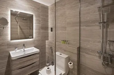 a bathroom with a toilet and a sink and a shower at Chic JLT Studio Lake View Metro 5min Marina in Dubai