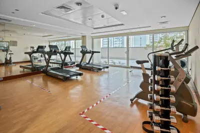 a gym with a bunch of exercise bikes in it at Chic JLT Studio Lake View Metro 5min Marina in Dubai