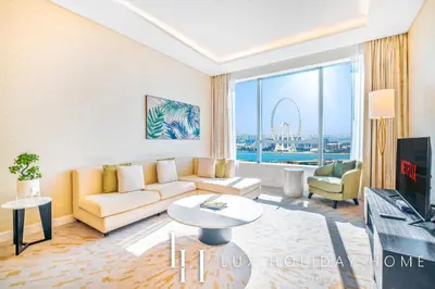 a living room with a couch and a tv at LUX Iconic Views at The Palm Tower Suite 5 in Dubai