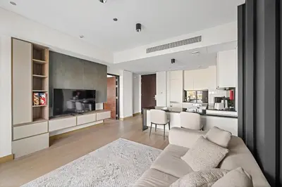 a living room with a couch and a kitchen at Burj Khalifa & Fountain From Your Balcony Near Dubai Mall & Metro in Dubai