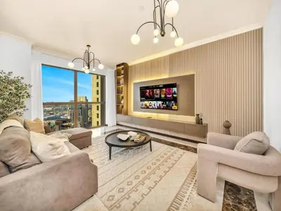 a living room with a couch and a table at Palm & Sea View 2BR JBR Beach Oasis 1 in Dubai