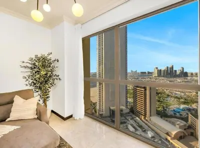 a bedroom with a large window with a view of the city at Palm & Sea View 2BR JBR Beach Oasis 1 in Dubai