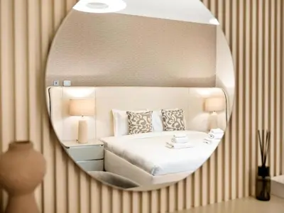 a mirror reflecting a bedroom with a bed in it at Palm & Sea View 2BR JBR Beach Oasis 1 in Dubai