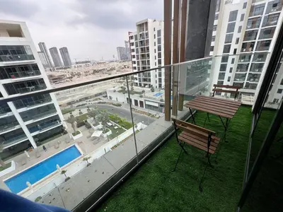 a balcony with a table and a bench on a building at Spacious Comfortable Apartment for your Family or you Group in Dubai