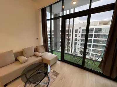 a living room with a couch and a large window at Spacious Comfortable Apartment for your Family or you Group in Dubai