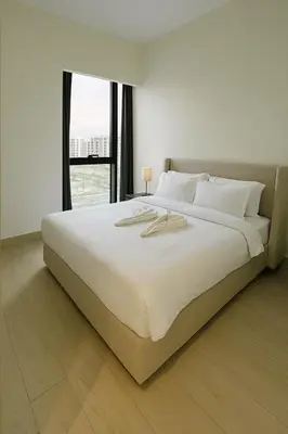 a large white bed in a room with a window at Spacious Comfortable Apartment for your Family or you Group in Dubai