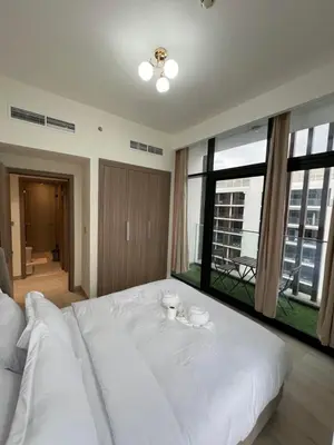 a large white bed in a room with large windows at Spacious Comfortable Apartment for your Family or you Group in Dubai