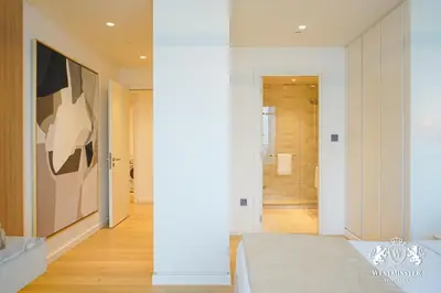 a bedroom with a large painting on the wall at Westminster Beach Front in Dubai