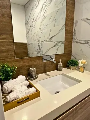 a bathroom with a sink and a mirror and towels at Luxury Burj Khalifa & Canal View Apartment, Business Bay, Downtown Dubai in Dubai