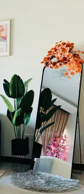 a mirror with some plants in a room at Luxury Burj Khalifa & Canal View Apartment, Business Bay, Downtown Dubai in Dubai