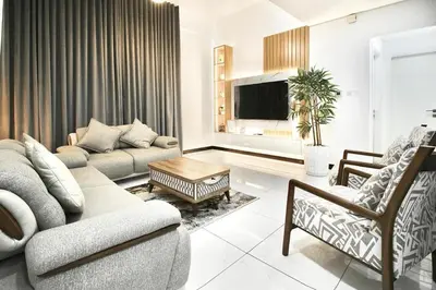 a living room with a couch and a tv at 2BR Duplex Stunning Views,Near Circle Mall & Park in Dubai