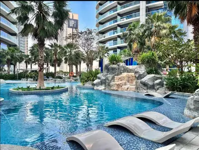 a large swimming pool with slides in a resort at Mahogany 1 - 2BR 6 PAX - Amazing Oasis - 1500 sqft in Dubai