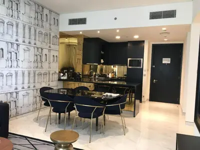 a kitchen with a table and chairs in a kitchen at Two Bedroom apartment in Millennium Atra Business Bay Dubai in Dubai