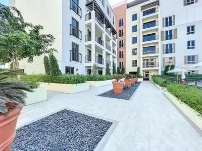 a courtyard in a apartment building with plants at La Sirene 3 - Elegant Two Bedroom in Jumeirah 1 in Dubai