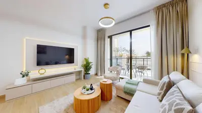 a living room with a couch and a tv at La Sirene 3 - Elegant Two Bedroom in Jumeirah 1 in Dubai