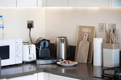a kitchen counter top with a microwave and appliances at High Floor Marina Gate 1 Bdr Flat Only Stays in Dubai