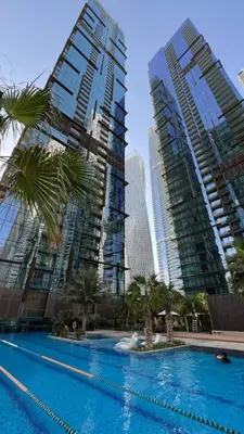 a swimming pool in front of some tall buildings at High Floor Marina Gate 1 Bdr Flat Only Stays in Dubai