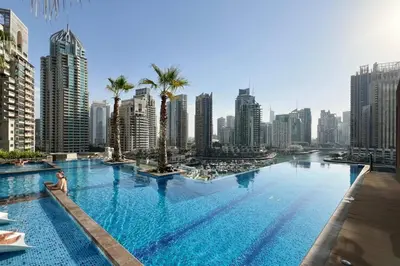 a large swimming pool in the middle of a city at High Floor Marina Gate 1 Bdr Flat Only Stays in Dubai