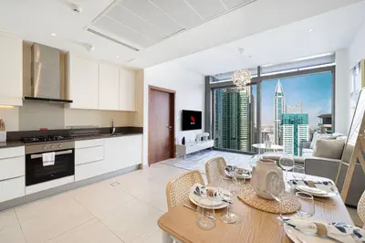 a kitchen and living room with a table and chairs at High Floor Marina Gate 1 Bdr Flat Only Stays in Dubai