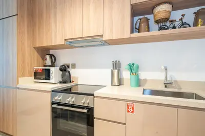 a small kitchen with a sink and a microwave at Sophisticated Studio Escape Luxury Design in Dubai
