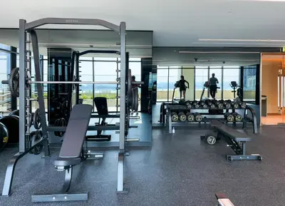 a gym with treadmills and machines in a building at Sophisticated Studio Escape Luxury Design in Dubai
