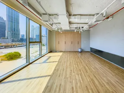 an empty room with wood floors and large windows at The Cinema Suite Luxury 2-Bed Near Dubai Mall in Dubai