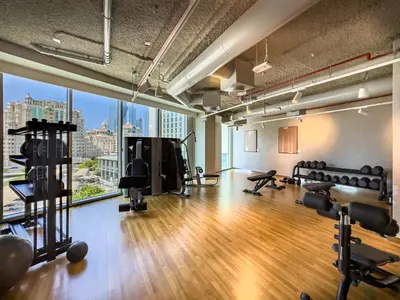 a gym with a view of a city skyline at The Cinema Suite Luxury 2-Bed Near Dubai Mall in Dubai