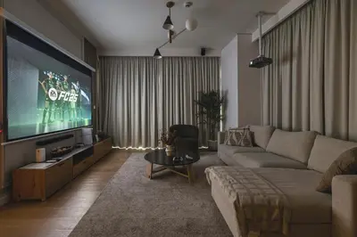 a living room with a couch and a tv at The Cinema Suite Luxury 2-Bed Near Dubai Mall in Dubai