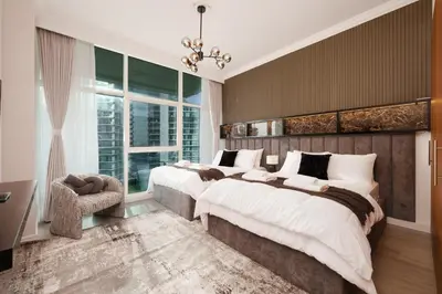 a bedroom with two beds and a window at Opulent Flat with Beach, Pool & Canal View in JBR in Dubai