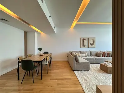 a living room with a table and a couch at Opulent Flat with Beach, Pool & Canal View in JBR in Dubai