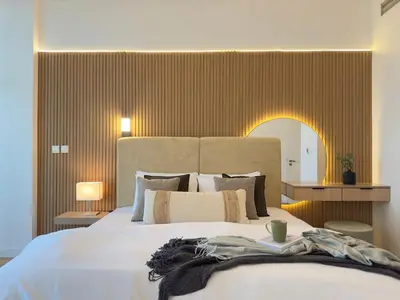 a bedroom with a large bed with a large headboard at Opulent Flat with Beach, Pool & Canal View in JBR in Dubai