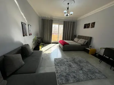 a living room with a couch and a table at Specious Fully furnished studio in May residence in Dubai