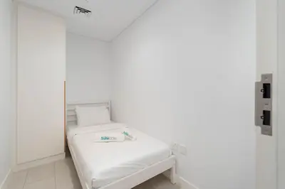 a white room with a bed and a mirror at Beautiful 2 Bedroom Sea Views at La Vie JBR in Dubai