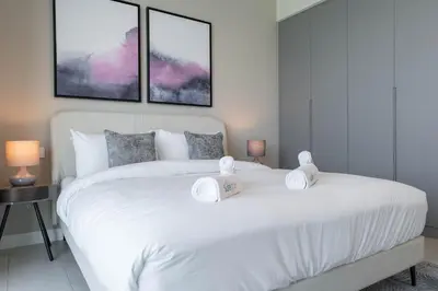 a bedroom with a large white bed with two pillows at Beautiful 2 Bedroom Sea Views at La Vie JBR in Dubai