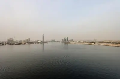 a large body of water with a city in the background at Waterfront 2BR with Dubai Skyline Views in Dubai