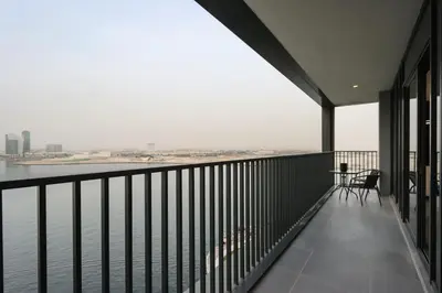 a balcony with a view of the water at Waterfront 2BR with Dubai Skyline Views in Dubai