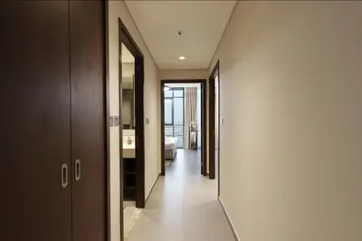 a hallway of a hotel room with a bedroom at Waterfront 2BR with Dubai Skyline Views in Dubai