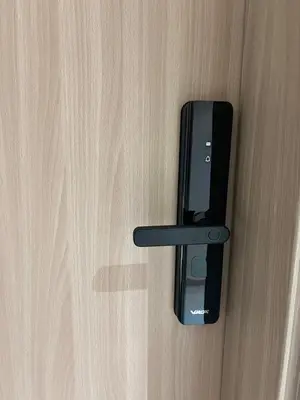 a black door handle on a wooden door at Brand New Studio Near Burj khalifa & Dubai Mall in Dubai