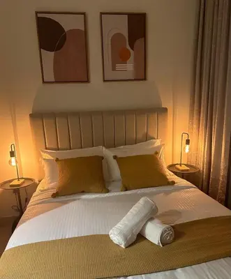 a bedroom with a bed with two lamps on it at Brand New Studio Near Burj khalifa & Dubai Mall in Dubai