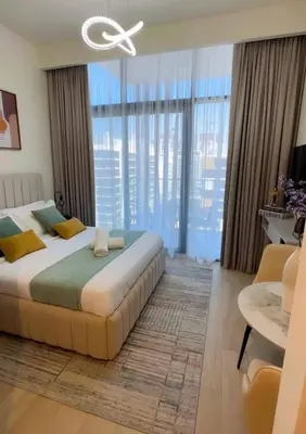 a bedroom with a large bed and large windows at Brand New Studio Near Burj khalifa & Dubai Mall in Dubai