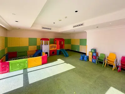 a childs play room with a play set and chairs at Frank Porter - Tajer Tower E in Dubai