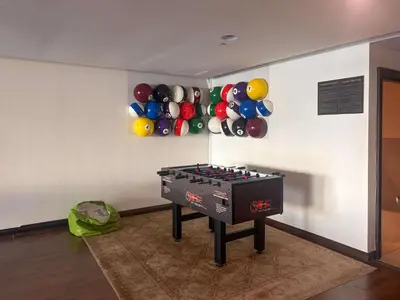 a room with a ping pong table and balloons on the wall at Frank Porter - Tajer Tower E in Dubai