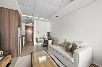 a living room with a couch and a table at Stunning Lake View Apartment in JLT in Dubai
