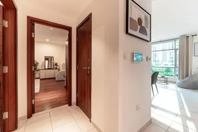 a hallway with a door leading to a living room at Chic 1-Bedroom Getaway with Downtown Living Charm in Dubai