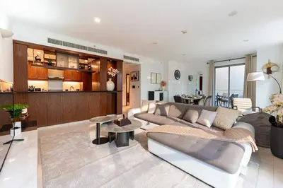 a living room with a couch and a table at Chic 1-Bedroom Getaway with Downtown Living Charm in Dubai