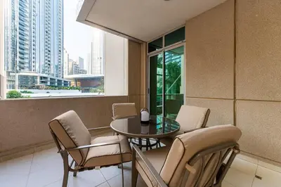 a balcony with a table and chairs in a building at Chic 1-Bedroom Getaway with Downtown Living Charm in Dubai