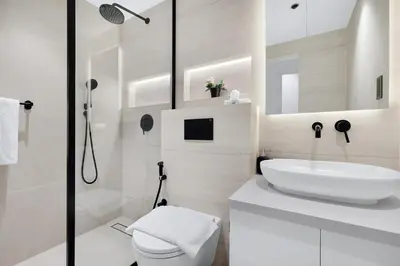 a white bathroom with a sink and a toilet at Luxury 2BR Apartment Near JBR Beach with Pool and Gym Access in Dubai